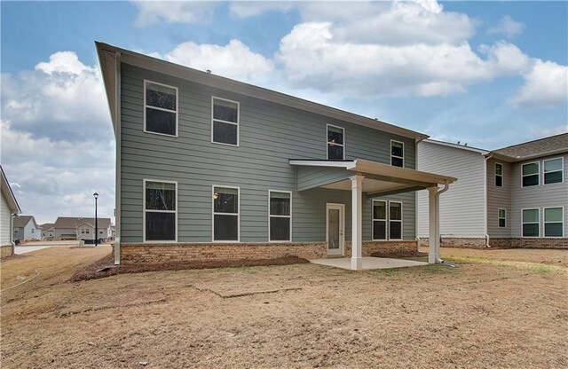 rear view of property featuring central AC unit, ceiling fan, a patio area, and a lawn