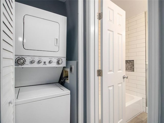 laundry room with stacked washer / dryer