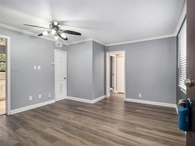 empty room featuring ceiling fan, dark hardwood / wood-style floors, and crown molding