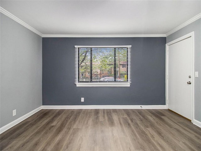 unfurnished room featuring dark wood-type flooring and ornamental molding