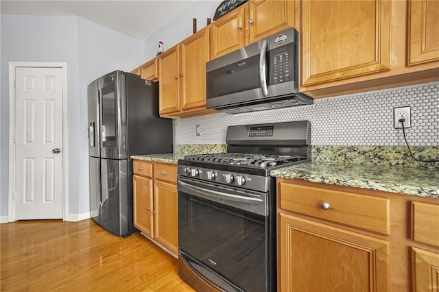 5989 Turfway Park Ct, Sugar Hill, GA 30518 - kitchen with appliances with stainless steel finishes, decorative backsplash, light wood-type flooring, and light stone countertops