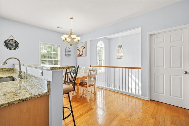 5989 Turfway Park Ct, Sugar Hill, GA 30518 - dining room featuring a chandelier and light wood-style flooring