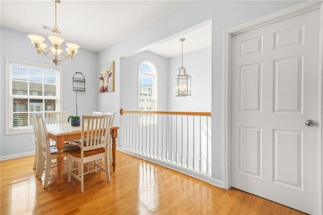 5989 Turfway Park Ct, Sugar Hill, GA 30518 - dining room featuring a chandelier, light wood-type flooring, and baseboards