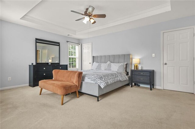 5989 Turfway Park Ct, Sugar Hill, GA 30518 - bedroom featuring a tray ceiling, light colored carpet, baseboards, ornamental molding, and a ceiling fan