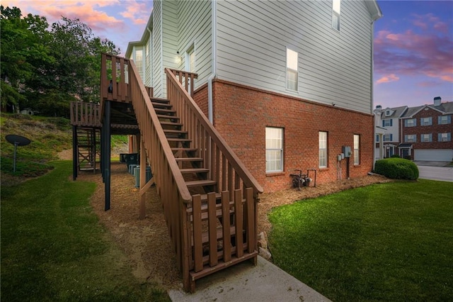 5989 Turfway Park Ct, Sugar Hill, GA 30518 - property exterior at dusk featuring stairway, brick siding, and a yard