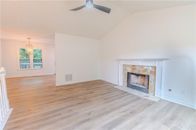 159 Aztec Way SE, Acworth, GA 30102 - unfurnished living room featuring a fireplace, ceiling fan, light wood-style floors, baseboards, and vaulted ceiling
