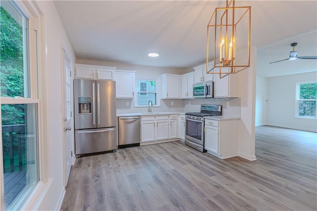 159 Aztec Way SE, Acworth, GA 30102 - kitchen with stainless steel appliances, a sink, light wood-type flooring, and white cabinetry