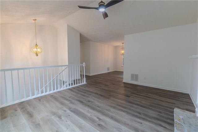 159 Aztec Way SE, Acworth, GA 30102 - unfurnished room featuring a chandelier, vaulted ceiling, a ceiling fan, wood finished floors, and baseboards