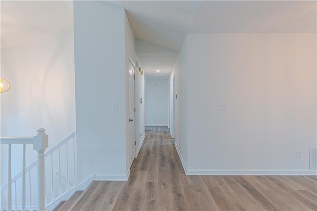159 Aztec Way SE, Acworth, GA 30102 - hallway with an upstairs landing, light wood-style flooring, and baseboards