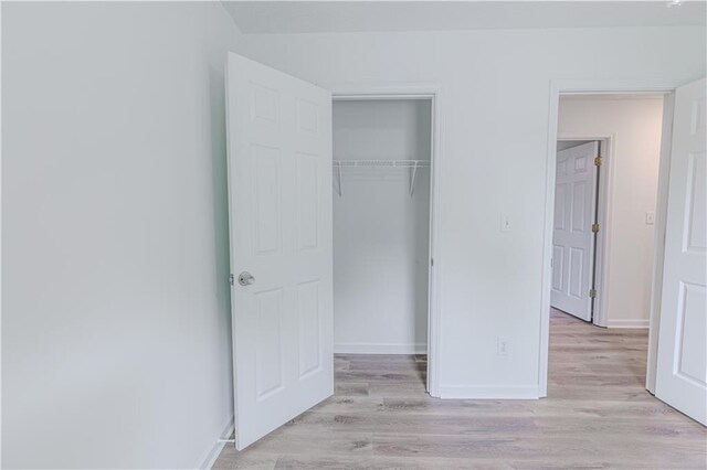 159 Aztec Way SE, Acworth, GA 30102 - unfurnished bedroom with light wood finished floors, a closet, and baseboards