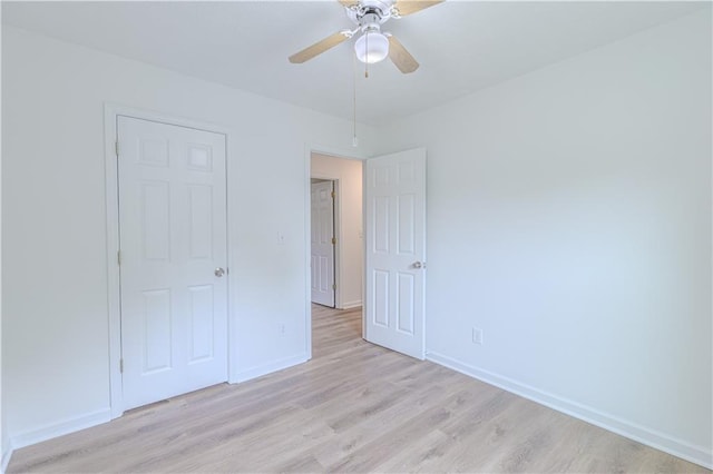 159 Aztec Way SE, Acworth, GA 30102 - unfurnished bedroom featuring light wood-style flooring, baseboards, and a ceiling fan