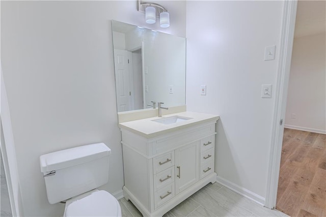159 Aztec Way SE, Acworth, GA 30102 - bathroom featuring vanity, toilet, baseboards, and wood finished floors