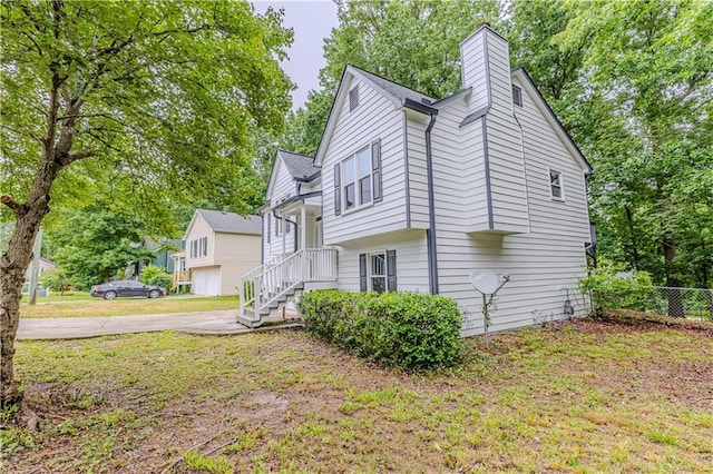 159 Aztec Way SE, Acworth, GA 30102 - view of side of home featuring a chimney, driveway, and view of scattered trees