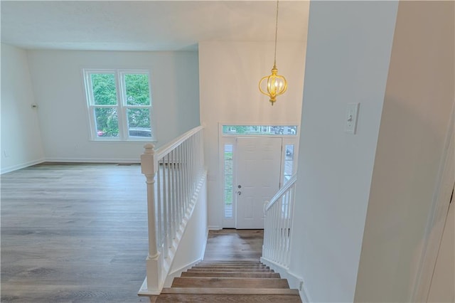 159 Aztec Way SE, Acworth, GA 30102 - foyer entrance with wood finished floors, a chandelier, stairway, and baseboards