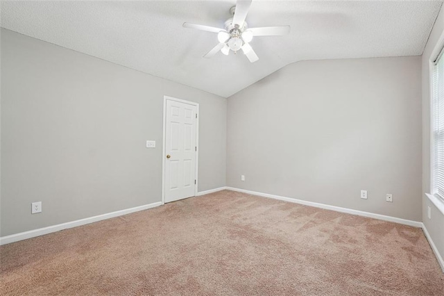 unfurnished room featuring a ceiling fan, light carpet, lofted ceiling, and baseboards
