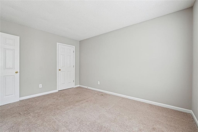 empty room with carpet flooring and baseboards