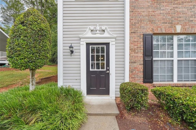 entrance to property with brick siding