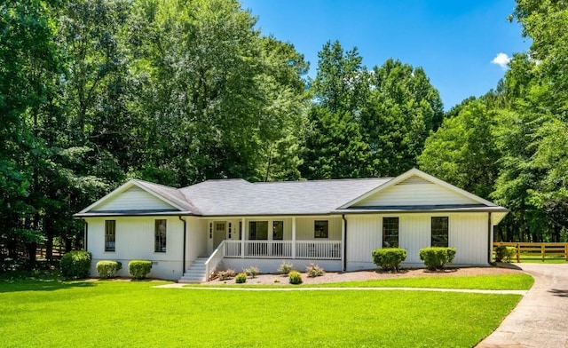 single story home with a porch, fence, a front yard, and crawl space