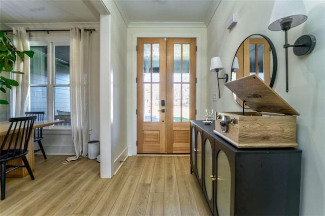 entryway featuring light wood-type flooring, crown molding, and french doors