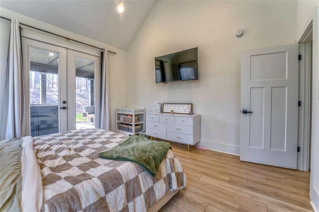 bedroom featuring access to exterior, french doors, vaulted ceiling, and light hardwood / wood-style flooring