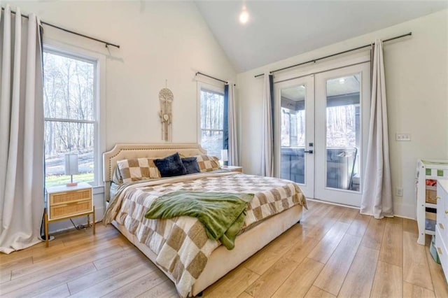 bedroom featuring access to exterior, french doors, multiple windows, and light wood-type flooring