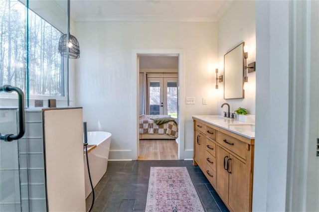 bathroom featuring french doors, vanity, independent shower and bath, and ornamental molding