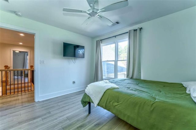 bedroom with hardwood / wood-style flooring and ceiling fan