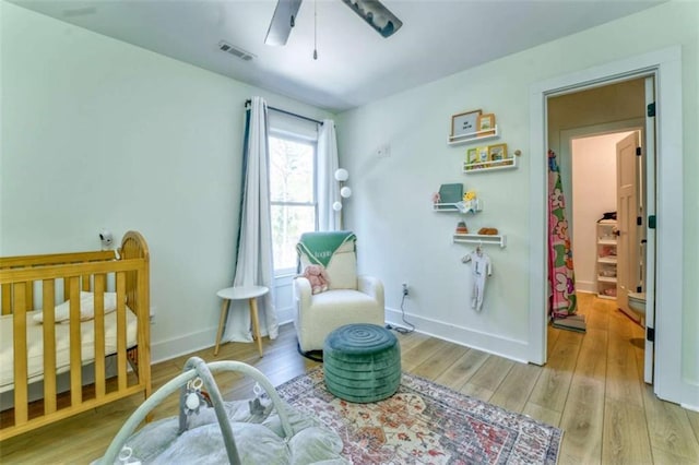 sitting room with light hardwood / wood-style flooring and ceiling fan