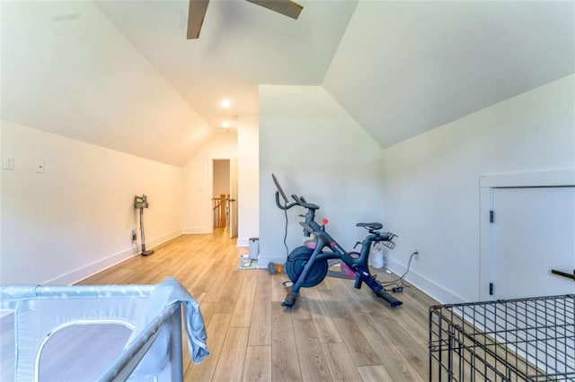 workout room with ceiling fan, lofted ceiling, and light wood-type flooring