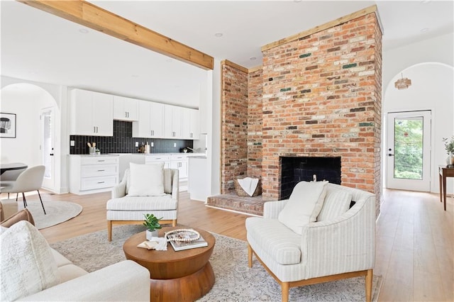2873 Bob White Dr SW, Atlanta, GA 30311 - living area featuring arched walkways, light wood-type flooring, and a fireplace