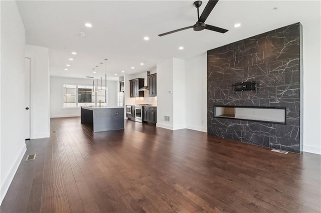 443 Plateau Pl NW, Atlanta, GA 30309 - unfurnished living room featuring baseboards, recessed lighting, a ceiling fan, a fireplace, and dark wood-type flooring