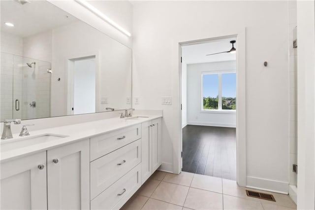 443 Plateau Pl NW, Atlanta, GA 30309 - bathroom with baseboards, visible vents, a stall shower, and a sink