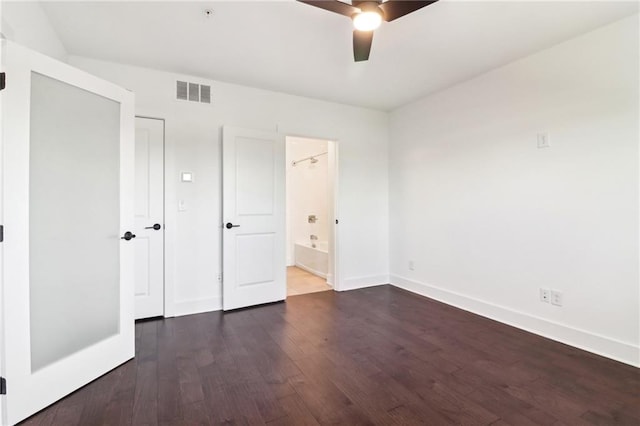 443 Plateau Pl NW, Atlanta, GA 30309 - unfurnished bedroom with wood finished floors, connected bathroom, ceiling fan, baseboards, and visible vents