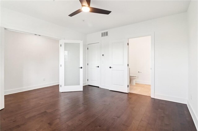 443 Plateau Pl NW, Atlanta, GA 30309 - unfurnished bedroom featuring a ceiling fan, ensuite bathroom, dark wood finished floors, baseboards, and visible vents