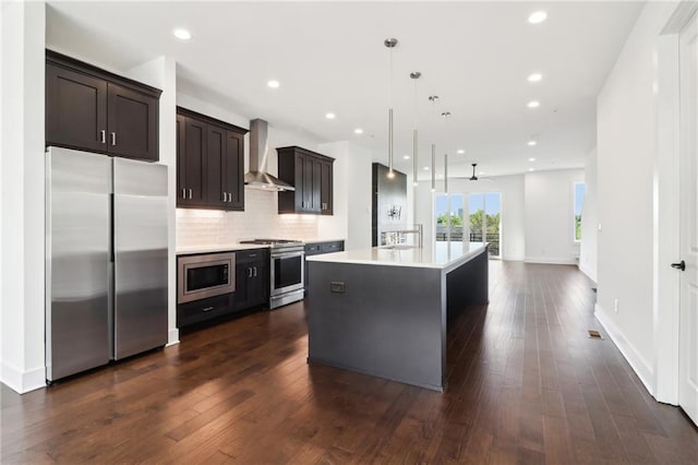 443 Plateau Pl NW, Atlanta, GA 30309 - kitchen with dark brown cabinets, a ceiling fan, wall chimney range hood, light countertops, and appliances with stainless steel finishes