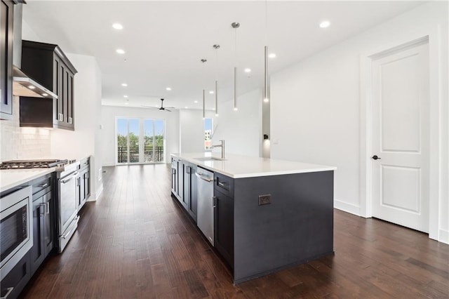 443 Plateau Pl NW, Atlanta, GA 30309 - kitchen with light countertops, dark wood-type flooring, appliances with stainless steel finishes, and a ceiling fan
