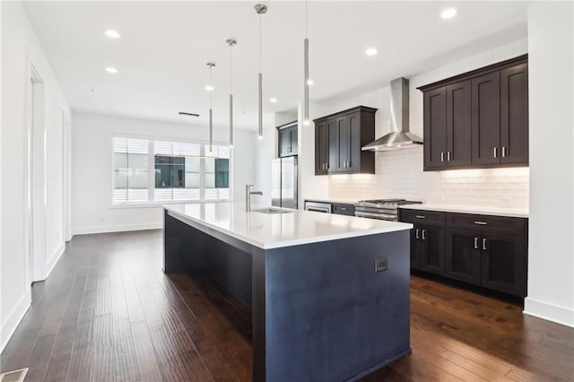 443 Plateau Pl NW, Atlanta, GA 30309 - kitchen with wall chimney exhaust hood, stainless steel appliances, a sink, dark wood finished floors, and light countertops