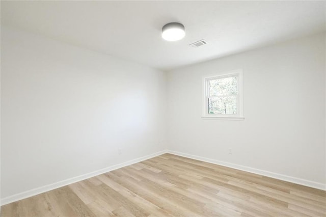 spare room with light hardwood / wood-style floors