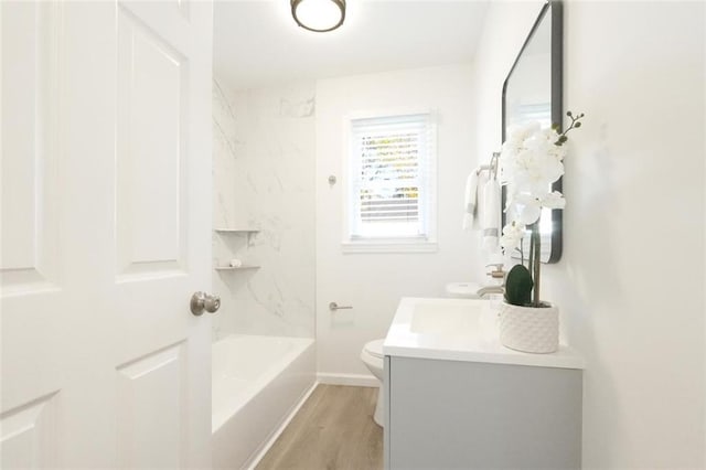 full bathroom with vanity, hardwood / wood-style floors, shower / bathtub combination, and toilet