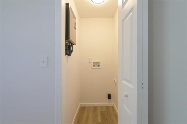 laundry area featuring hookup for a washing machine and light wood-type flooring