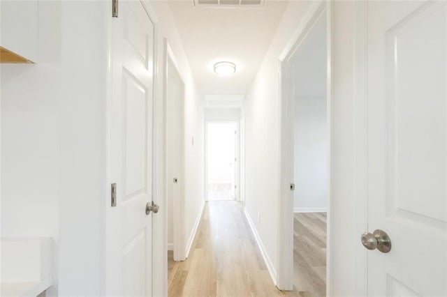 hall with light hardwood / wood-style flooring