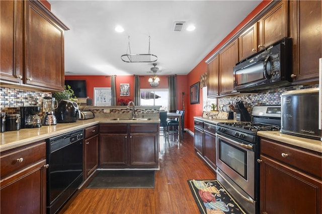 kitchen featuring sink, tasteful backsplash, dark hardwood / wood-style flooring, kitchen peninsula, and black appliances