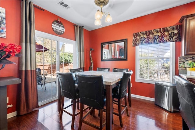 dining room featuring a notable chandelier and dark hardwood / wood-style floors