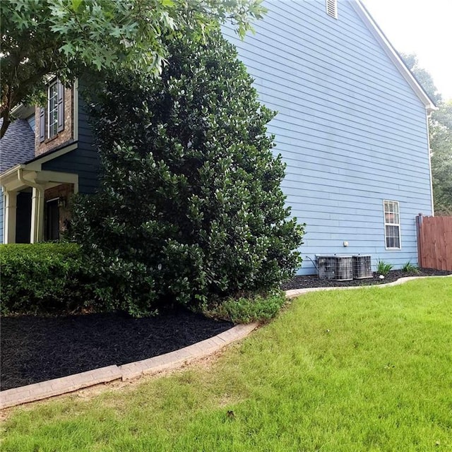 view of property exterior featuring a yard and central air condition unit