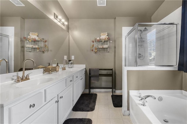 bathroom with tile patterned floors, ceiling fan, a bathtub, and vanity