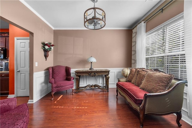 living area featuring crown molding and hardwood / wood-style flooring