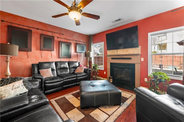 living room featuring ceiling fan, hardwood / wood-style floors, and plenty of natural light