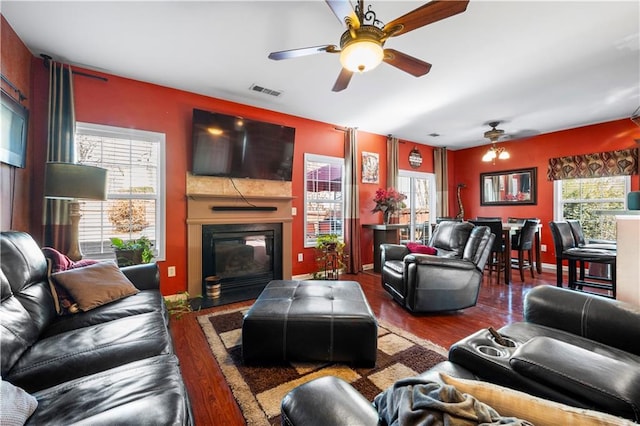 living room with dark hardwood / wood-style floors and ceiling fan