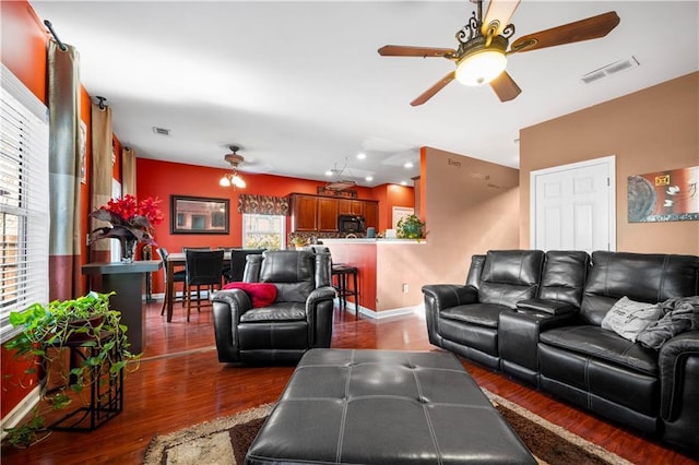 living room featuring hardwood / wood-style floors and ceiling fan