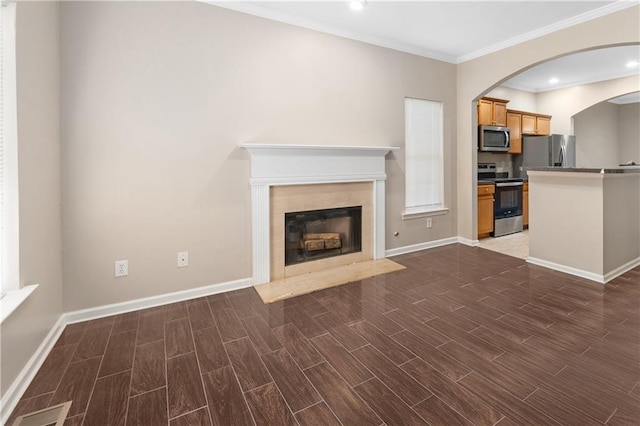 unfurnished living room featuring dark hardwood / wood-style flooring and ornamental molding